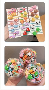 Close-up of assorted colorful cartoon hair ties for kids in a jar and on cards