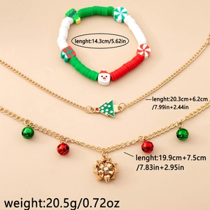 Detailed view of Christmas charm bracelet and necklaces with Santa and bell pendants