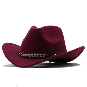 Close-up of wine red wool fedora with woven belt and metal stud accents on brim