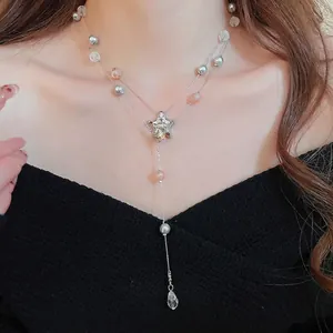 Double-layer silver necklace with star pendant, gray pearls and pink beads on a model