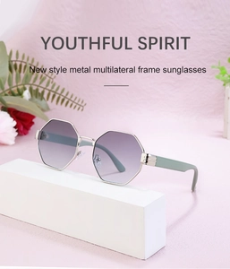 Detail of polygonal silver metal sunglasses with purple gradient lenses on pink backdrop