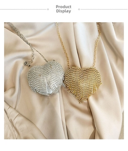 Detailed view of luxury heart-shaped evening bags with rhinestones and metal chains