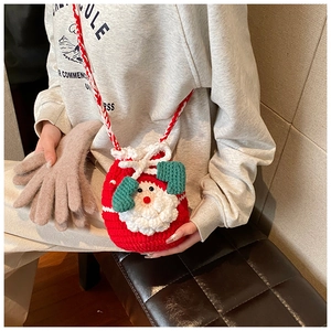 Detail of handmade crochet Santa bag with red yarn texture and white beard decoration