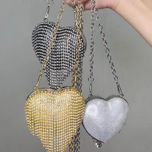 Mini heart-shaped rhinestone evening bags in black, gold, and silver with chain straps
