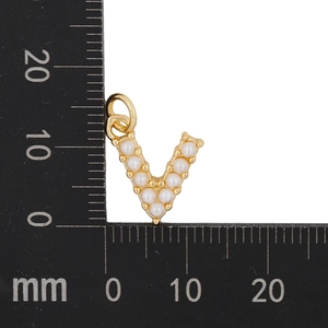 Detail view of a gold-plated letter V pendant with white pearls measuring 13mm by 15mm