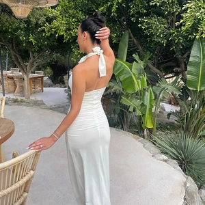 Detail of white halter neck maxi dress with elegant back pleats and ruched design