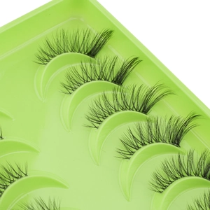 Close-up of natural black half eyelashes in a green tray with dense clusters