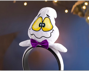 Detail of plush Halloween headband featuring a cute white ghost with a purple bow accent