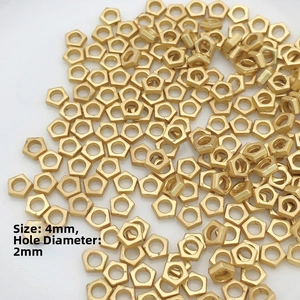 Macro detail of 4mm gold hexagonal spacer beads with 2mm hole for DIY jewelry making