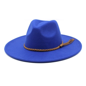 Close-up of royal blue wool fedora hat with wide brim and brown braided belt detail