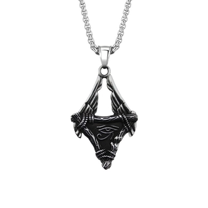 Detailed macro view of vintage stainless steel Horus eye and winged triangle pendant