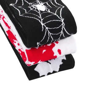 Close-up detail of Halloween socks with spider web, blood splatter, and bat patterns