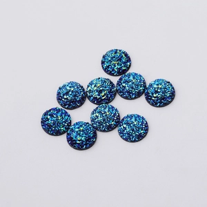 Macro detail of 12mm blue resin rhinestones with sparkling starry mineral texture