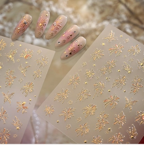 Detail of gold firework nail stickers on gradient pink almond-shaped false nails