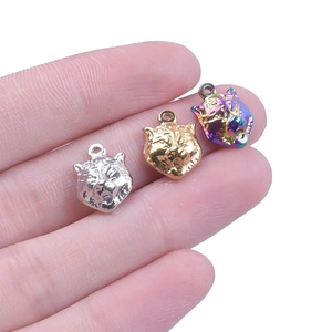 Macro shot of tiger head pendants in silver, gold, and rainbow finish for jewelry making