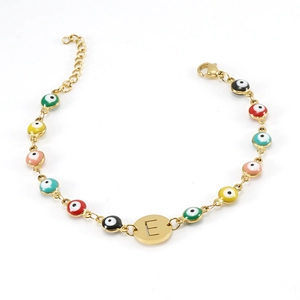 Detail of 18K gold stainless steel evil eye bracelet with colored enamel and E initial