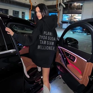Detailed back view of oversized black hoodie featuring bold letter prints and warm fleece