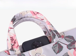 Close-up of durable reinforced handle and floral print on laptop sleeve bag