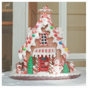 Detailed view of gingerbread candy house with artificial snow and miniature snowman