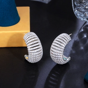 Silver C-shape hoop earrings with gradient pave cubic zirconia on black reflective surface