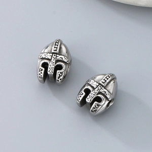 Macro shot of two silver stainless steel Spartan helmet spacer beads for jewelry making
