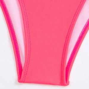 Macro detail of pink bikini bottoms showing premium double-stitched seams and elastic fabric