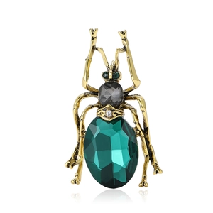 Vintage beetle brooch in gold alloy with green crystal and sparkling rhinestones