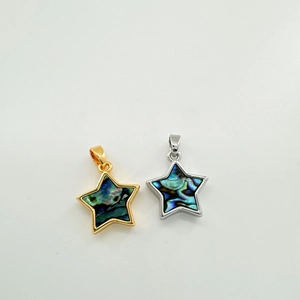Macro shot of 18K gold plated star pendants with natural shell inlay for DIY jewelry