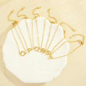 18K gold plated minimalist letter bracelets featuring O P Q R S T on shell tray