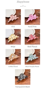 Close-up of floral acetate hair claws in various colors with sparkling rhinestone centers