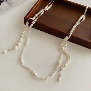 French vintage pearl chain necklace with crystal beads and teardrop pendants on wood