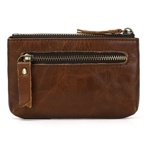 Detail view of brown genuine leather coin purse with vintage brass zippers and texture