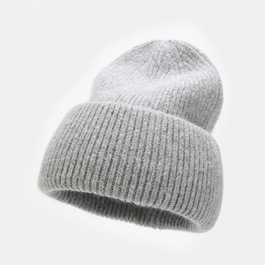Close-up of gray knit beanie showing detailed soft angora wool texture and folded brim