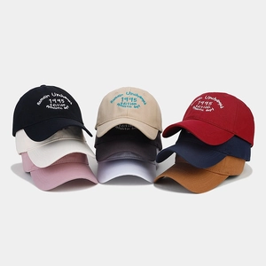 Detailed view of nine vintage embroidered cotton baseball caps in multiple colors