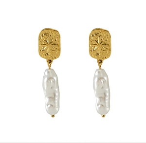 Detail of gold star engraved metal earring with a hanging white baroque pearl