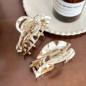 Acetate hair claw clip set in coffee marble pattern displayed on a wooden surface