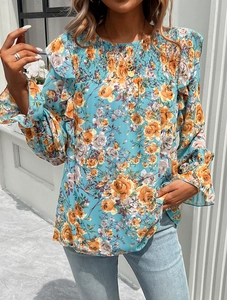 Detail of floral print blouse showing smocked chest and ruffled shoulder accents