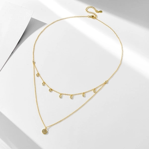 Close-up of double-layer gold necklace with micro-pave zircon disk and 925 silver stamp