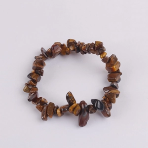 Close-up of natural irregular tiger eye stone fragments on an elastic beaded bracelet