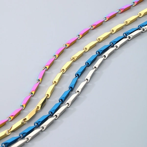 Macro detail of polished stainless steel link chains in gold, blue, silver and rainbow colors
