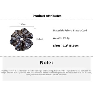 Detail view of plaid fabric scrunchie showing measurements 19.2cm by 15.8cm and 49.3g weight