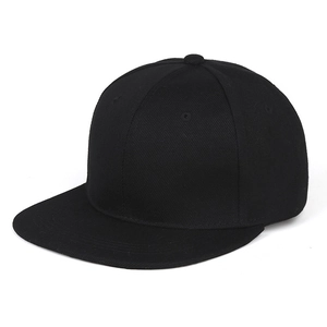 Close-up of black cotton flat brim snapback hat showing six-panel crown and top eyelets