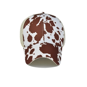 Detailed cow print front panel and beige breathable mesh on the back of the ponytail baseball cap