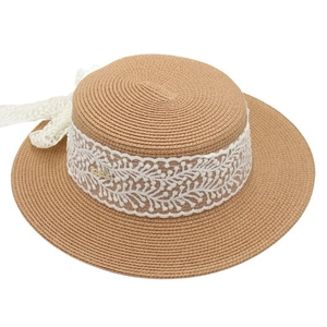 Détail du chapeau de paille à sommet plat avec ruban en dentelle et breloque abeille