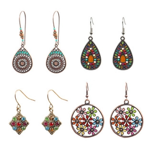 Detail of bohemian earring set featuring vintage red gemstones and geometric patterns