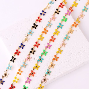 Chic enamel butterfly metal chains in multiple colors on white textured stone base