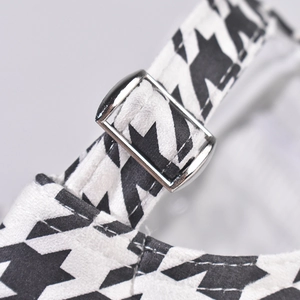 Detail of houndstooth baseball cap with adjustable silver metal buckle and neat stitching