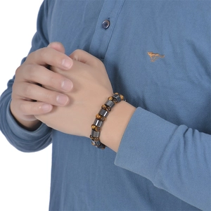 Detail of double-layer tiger eye stone bracelet with magnetic metal beads on wrist