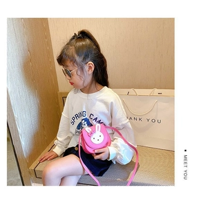 Pink PU mini crossbody bag for girls featuring a cute white rabbit design and bow detail