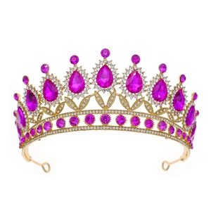 Detailed close-up of golden bridal crown featuring elegant magenta teardrop gemstones